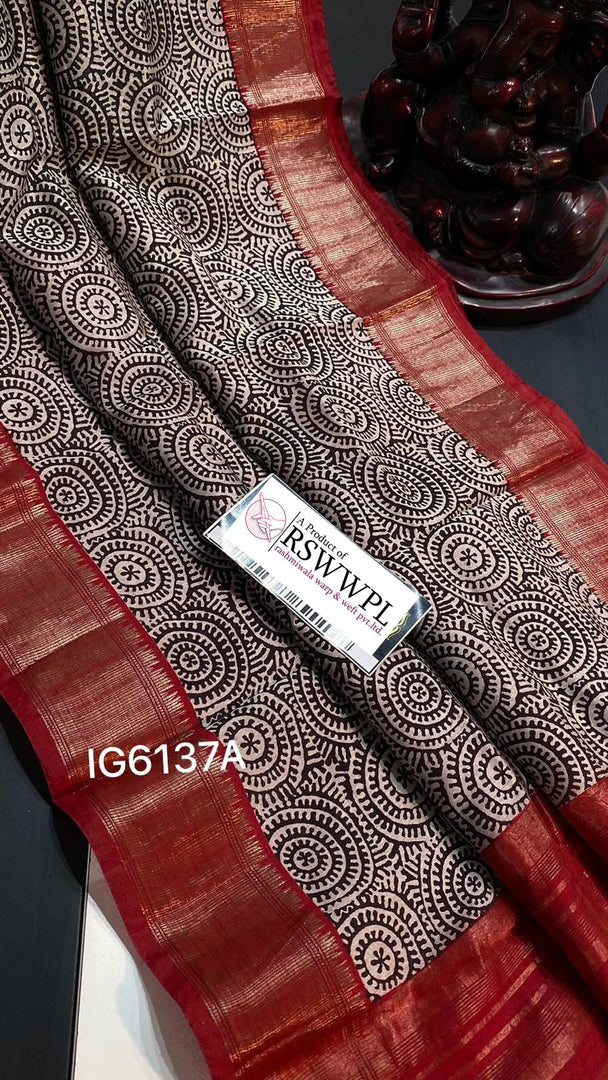 Stunning Black Assmi Pattu saree with striking red border detailing.