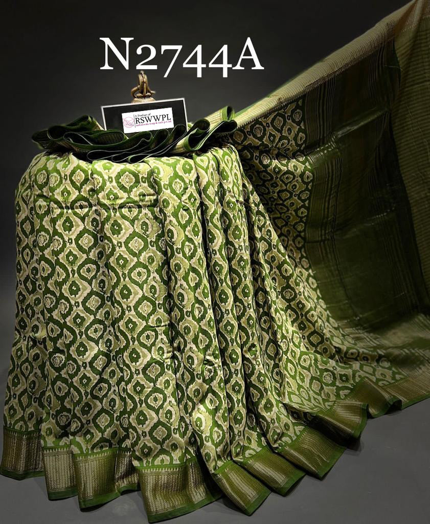 Elegant green Dola silk saree with beautiful prints, blending traditional charm with modern elegance