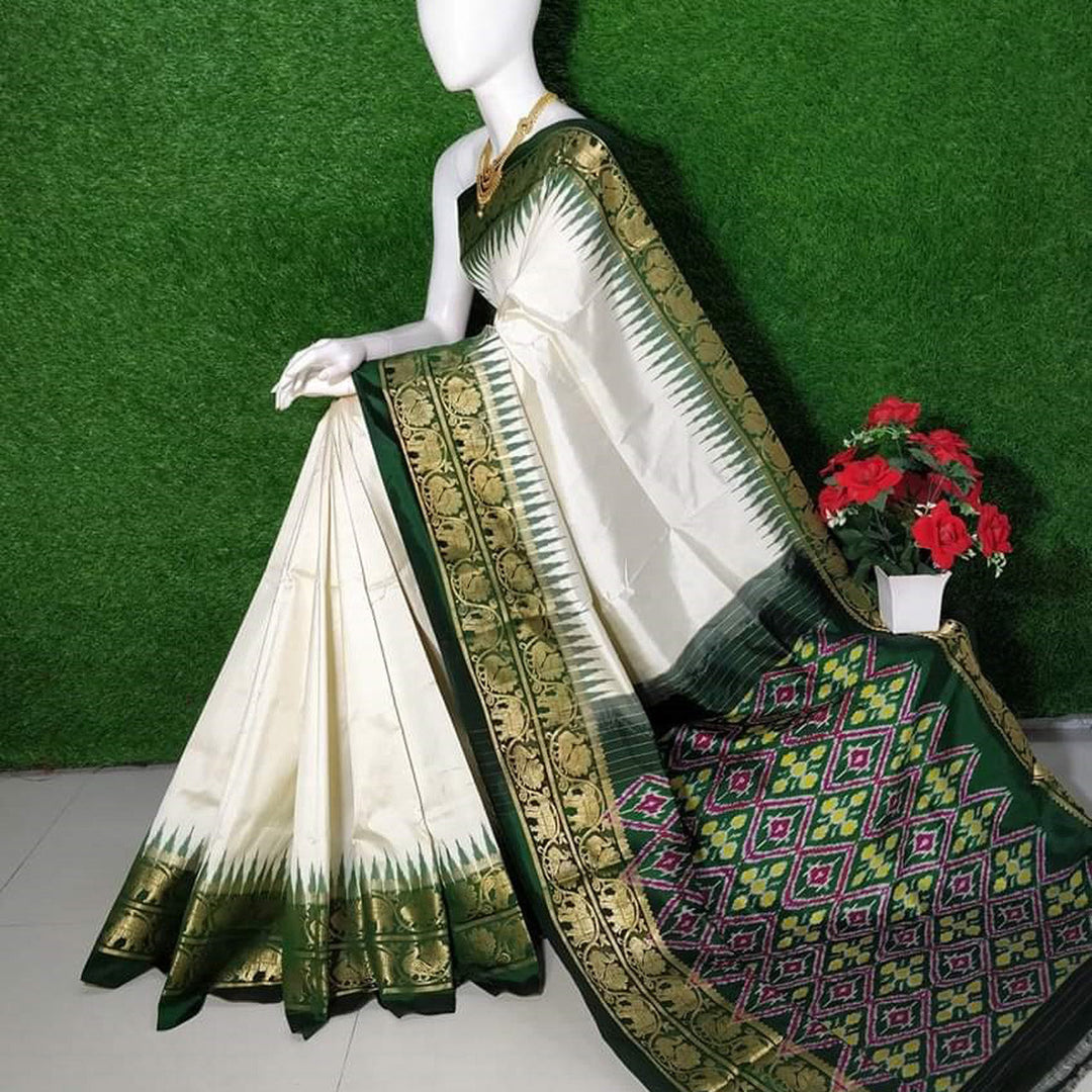 White Regal Weave Silk Saree With Traditional Kanchi Border And Patola Accent