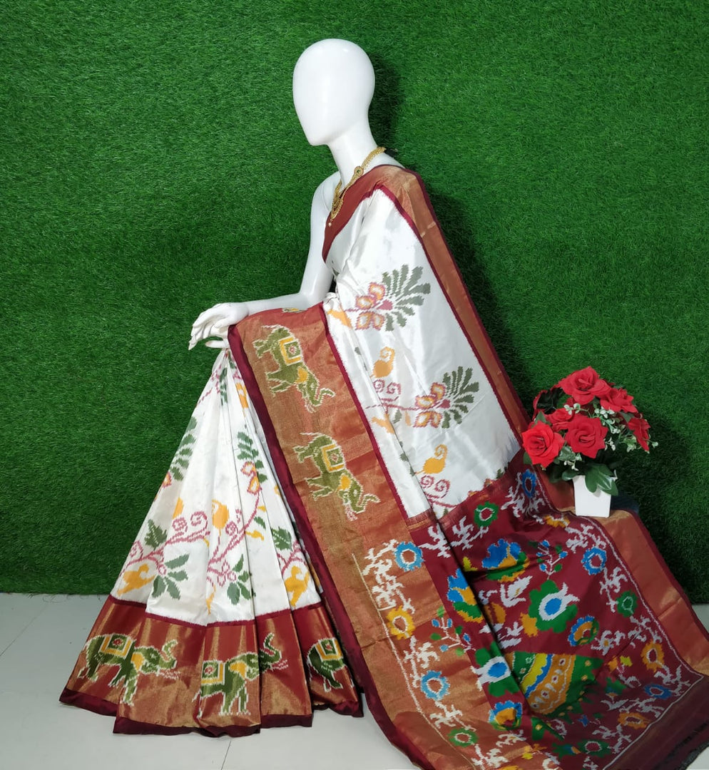 Graceful White Handloom Silk Saree With Ethnic Ikkat Prints